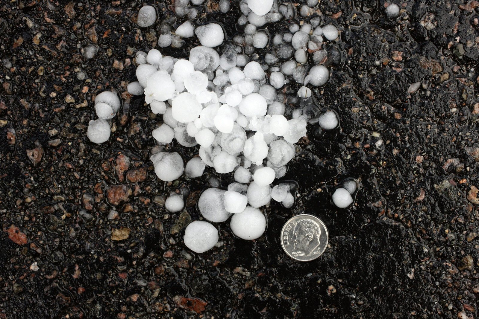 Hands mixing perlite into dark potting soil in a bowl