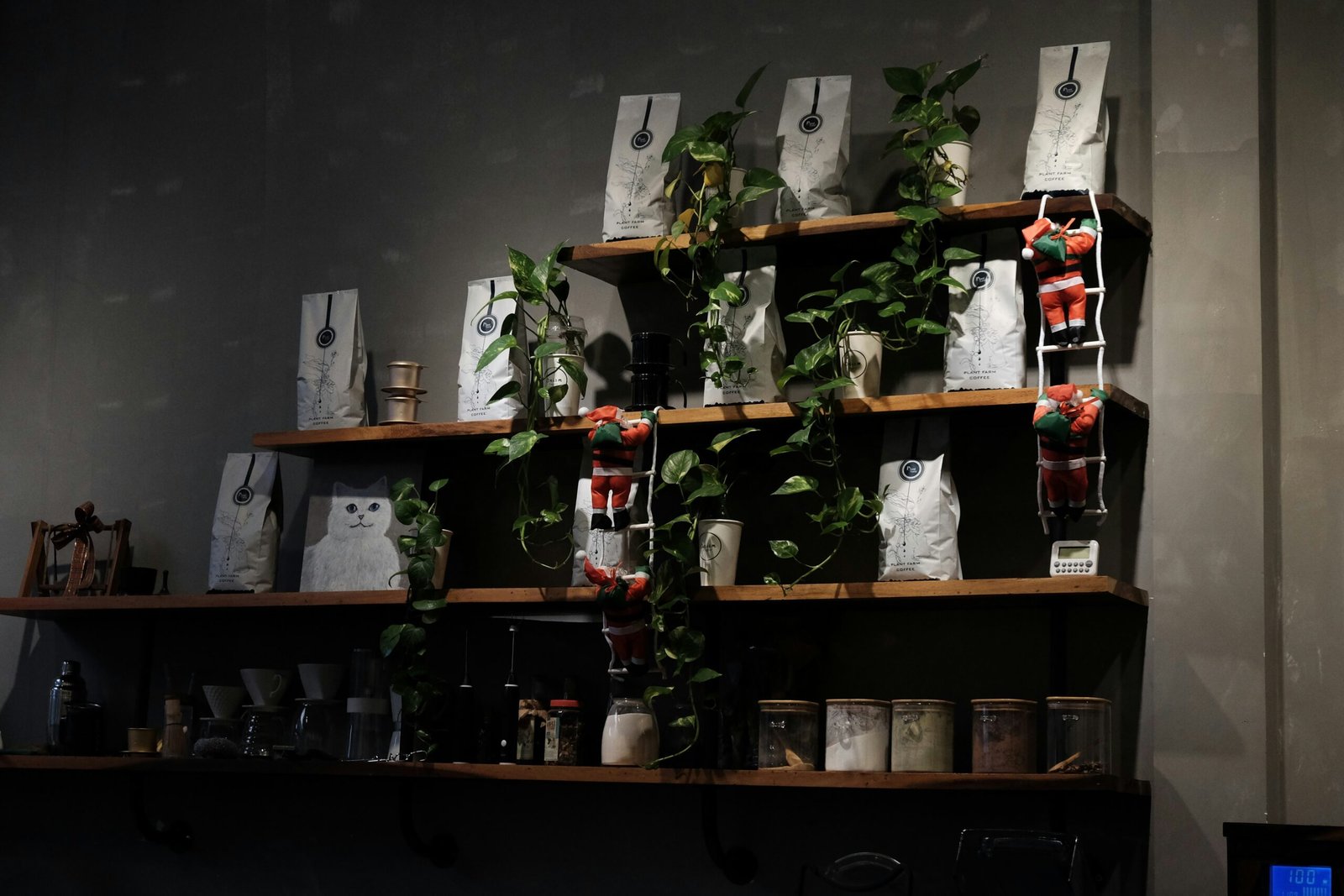 A 3-tier wooden plant stand with mixed houseplants at different heights in a sunny apartment corner