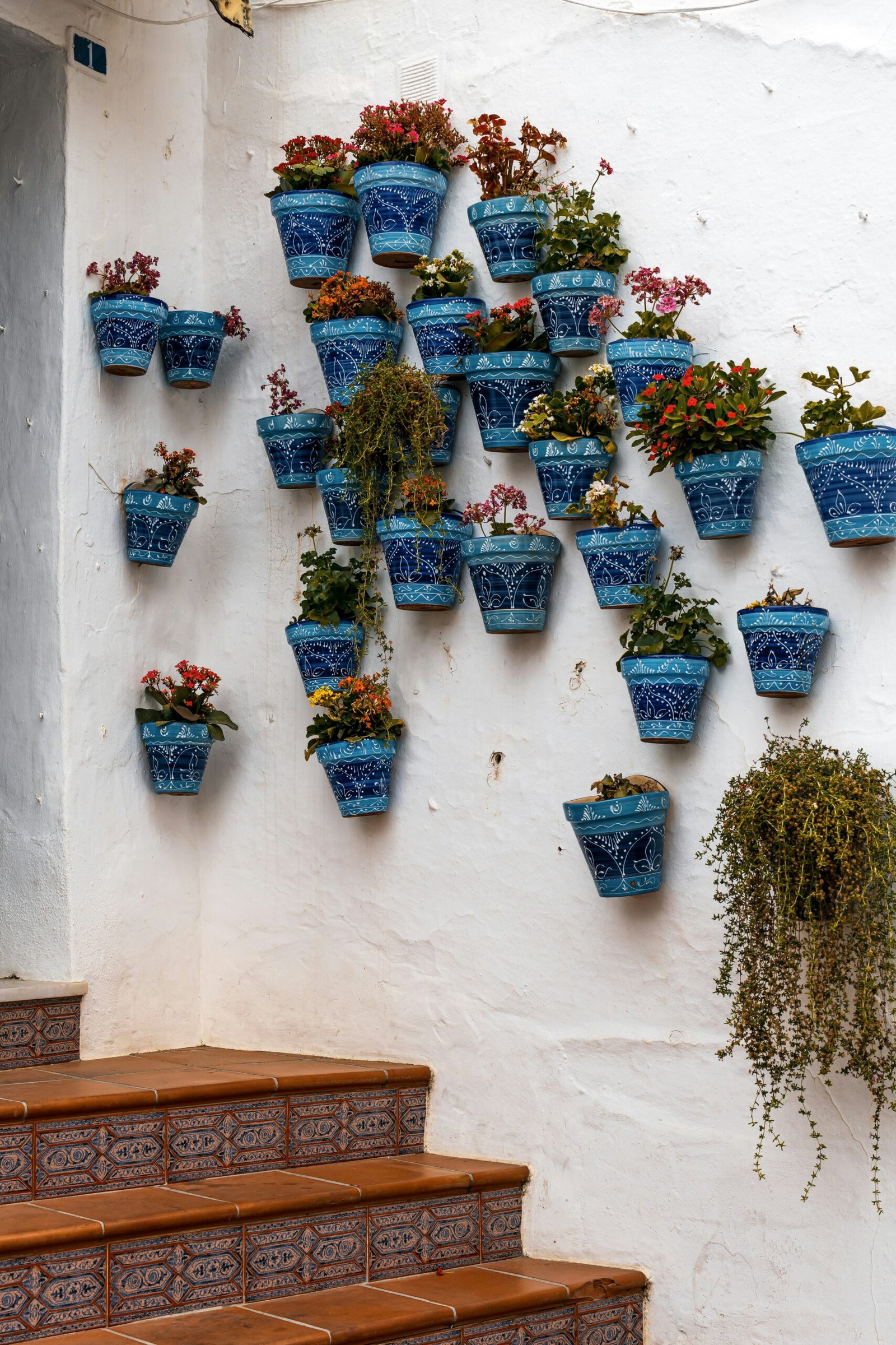 Close-up of a felt pocket vertical planter being filled with potting soil and herb seedlings