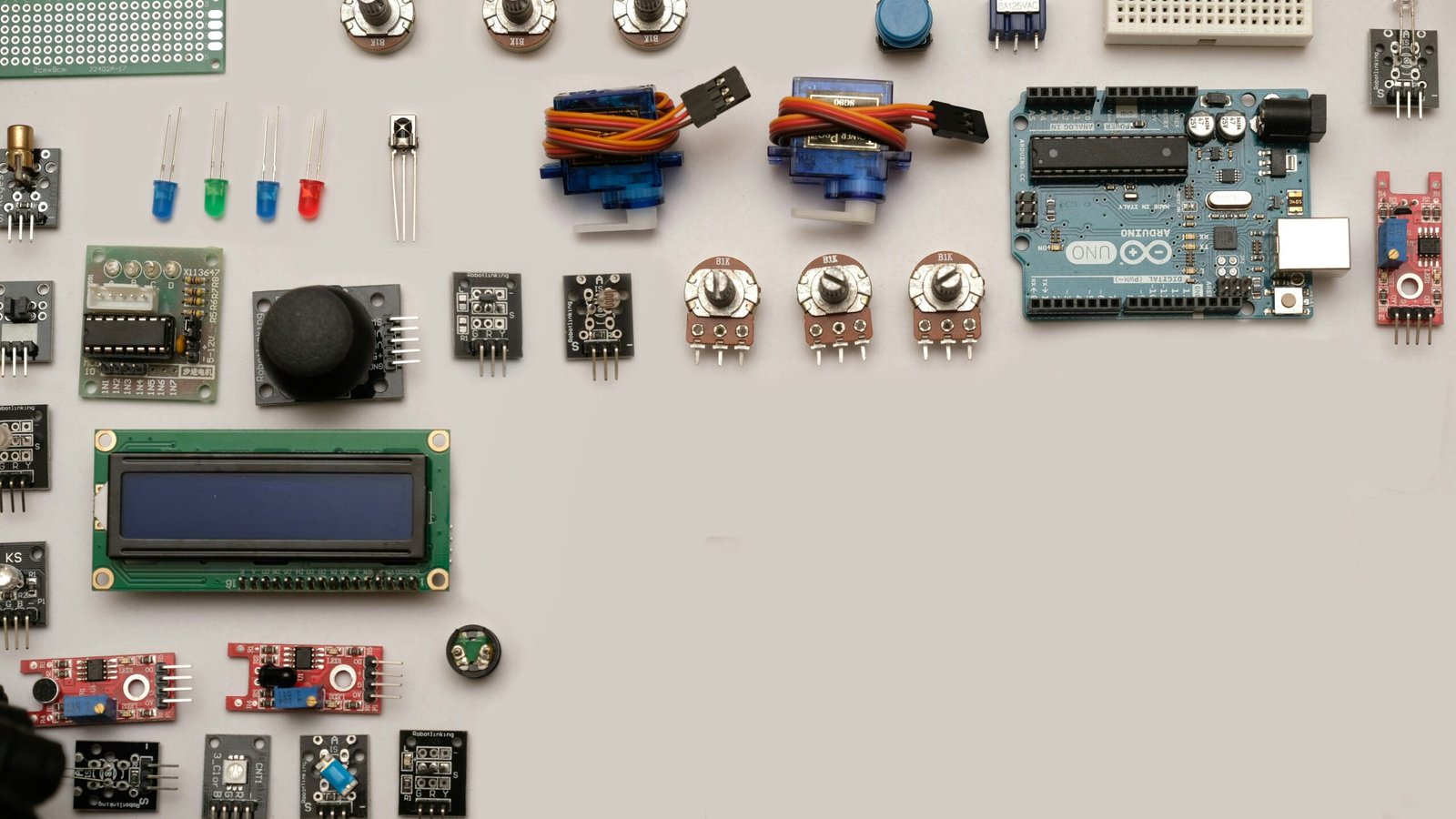 Close-up of a capacitive soil moisture sensor and a small Arduino board on a breadboard